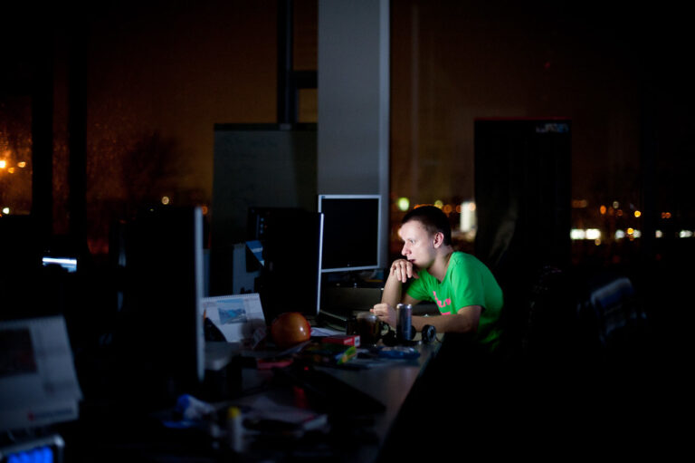 Working at a desk in a dark room