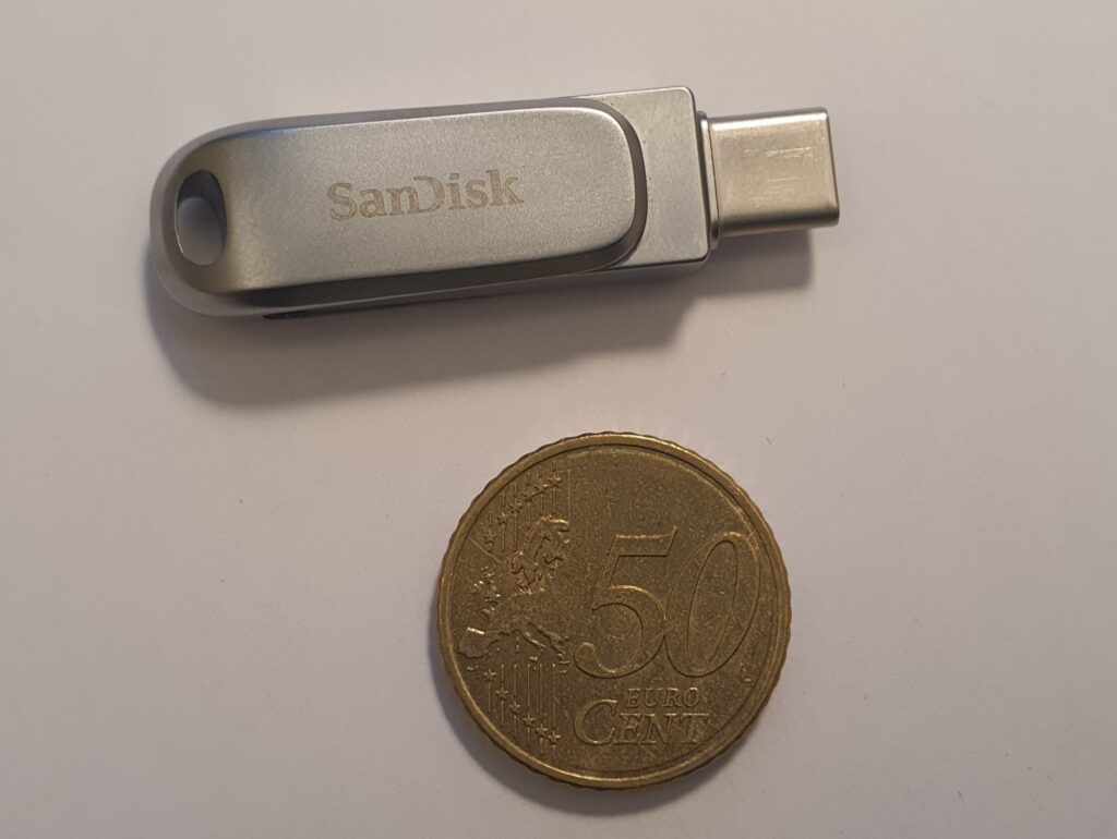 USB flash drive beside a coin